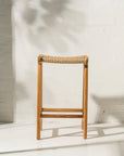 Wooden stool with woven seat